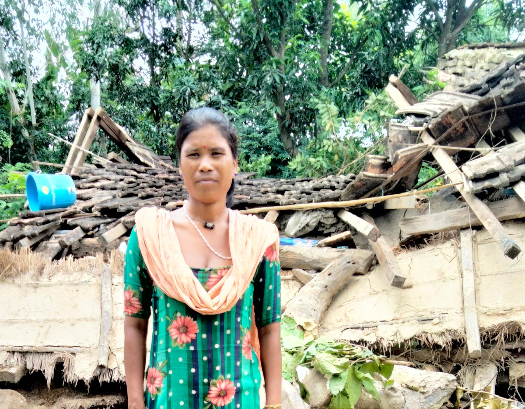 Rekha Chaudhary in front of her house, which was damaged in the floods. Photo: LWF Nepal