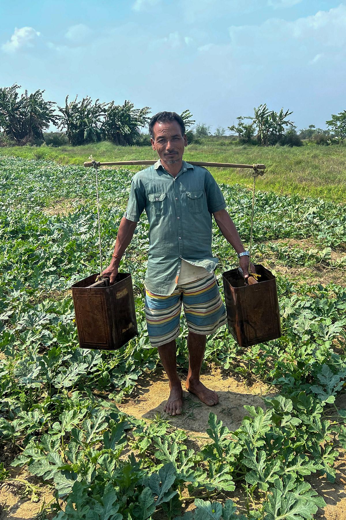 A farmer in Morang district showing labor-intensive irrigation in riverbed farming. Photo: LWF/ S. Muis