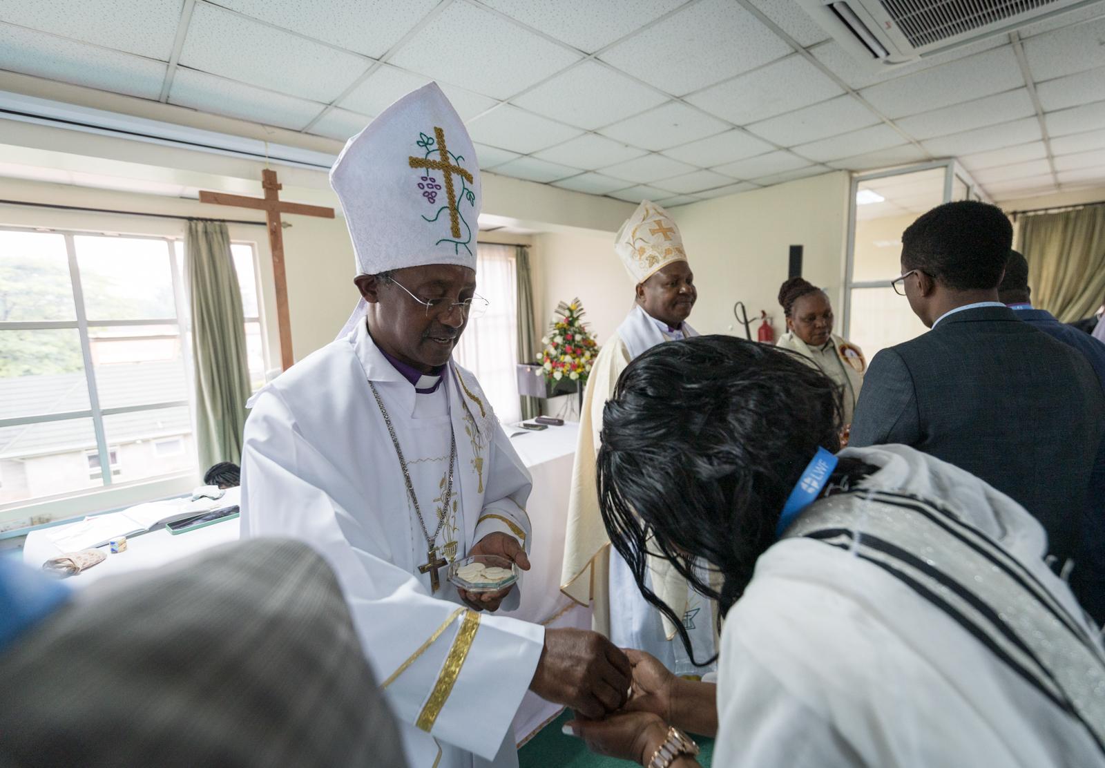 Bishop Johnes Meliyio of the Kenya Evangelical Lutheran Church distributes bread for holy communion.