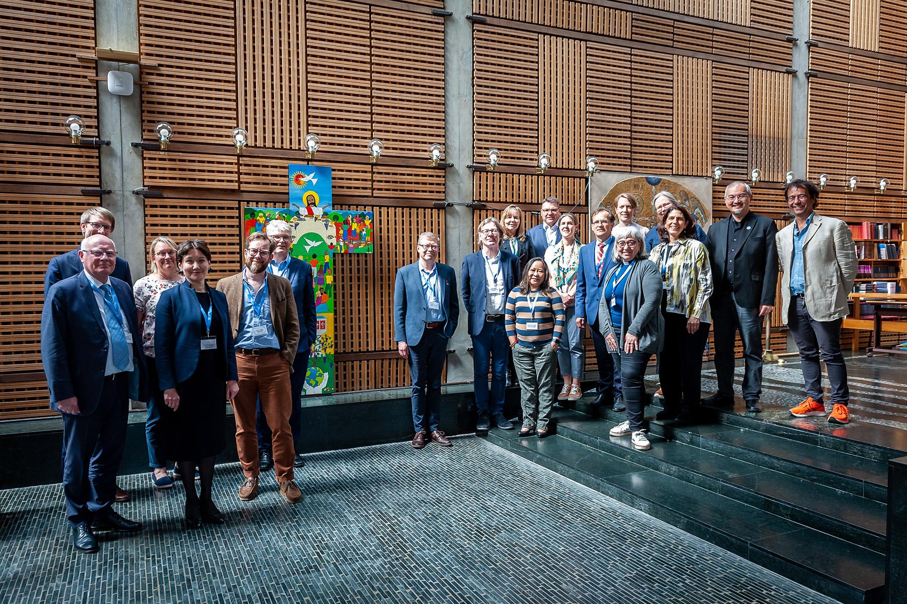 Participants and LWF leadership gather around the Lund cross in the Ecumenical Center chapel. Photo: LWF/ S. Gallay
