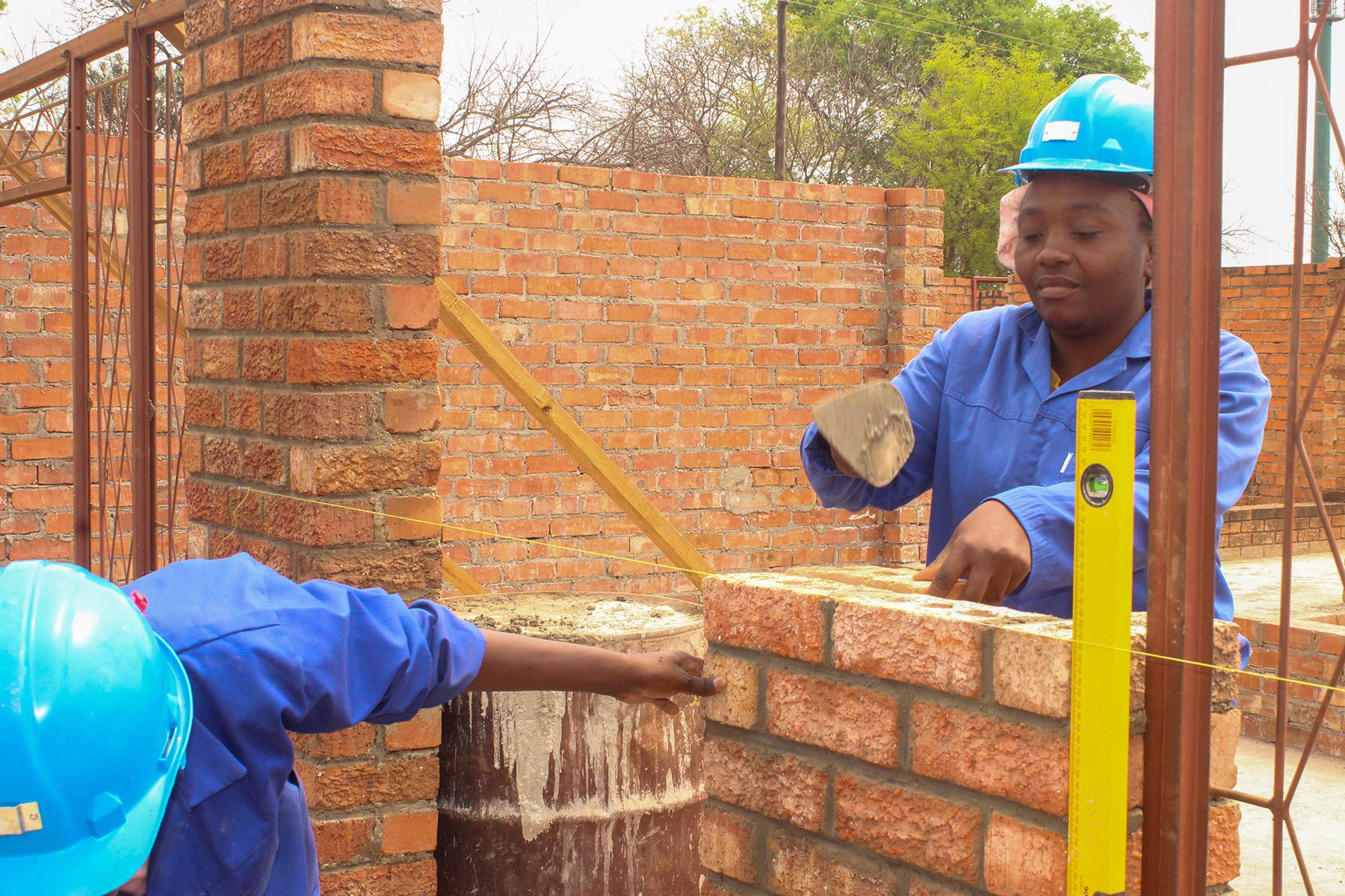 Auf der Baustelle der öffentlichen Hand in Filabusi im südlichen Simbabwe demonstriert Nomathemba Sibanda ihr Können als Maurerin. Foto: LDS