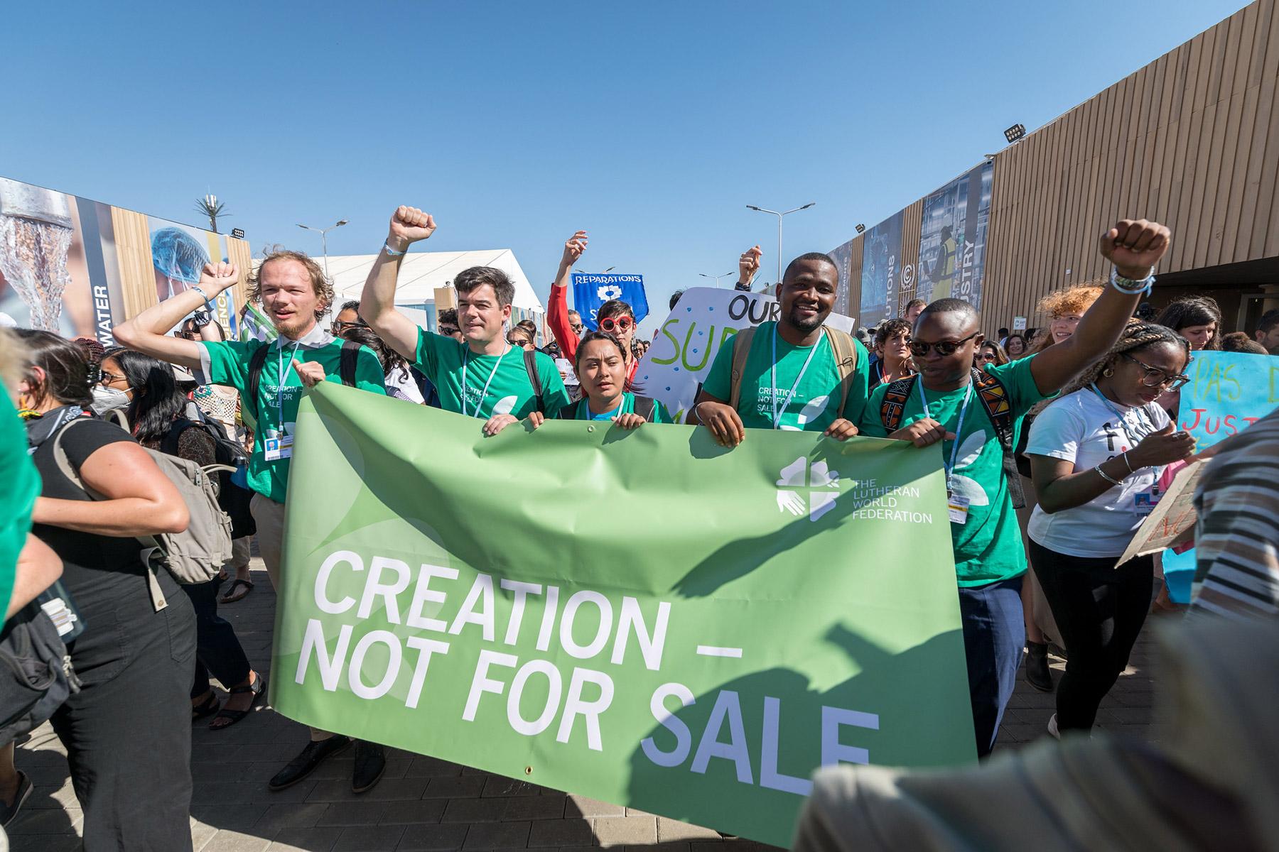 Young delegates from the Lutheran World Federation join hundreds of people from civil society organizations and faith communities across the globe to march through the venue of the United Nations climate change conference COP27 in Sharm el-Sheikh, Egypt, calling for climate justice and urgent action. Photo: LWF/Albin Hillert