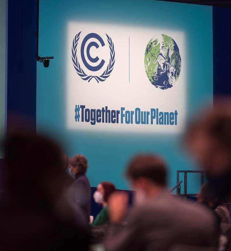 'Together for our planet' reads a sign on Finance day in the Cairn Gorm plenary hall at COP26. Glasgow hosts the United Nations climate change conference COP26, where world leaders gather to negotiate a response to the ongoing climate crisis and emergency. Photo: LWF/Albin Hillert