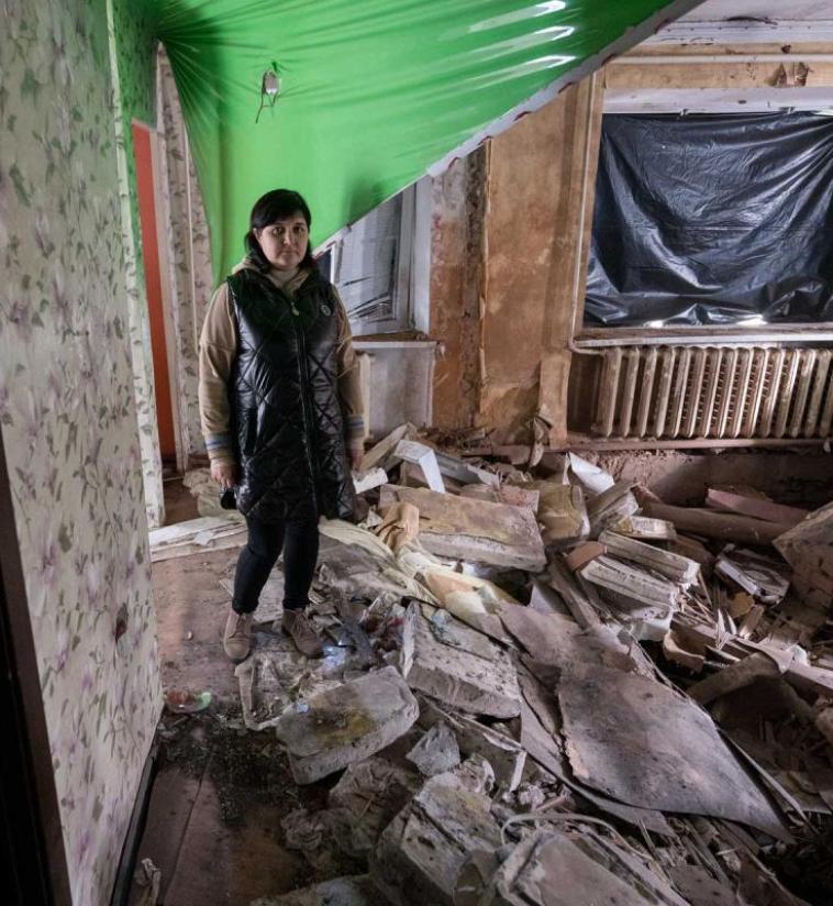     41-year-old Victoria Hlushko pictured in what used to be the living room of her family home in the village of Bil’machivka. Photo: LWF/ Albin Hillert 