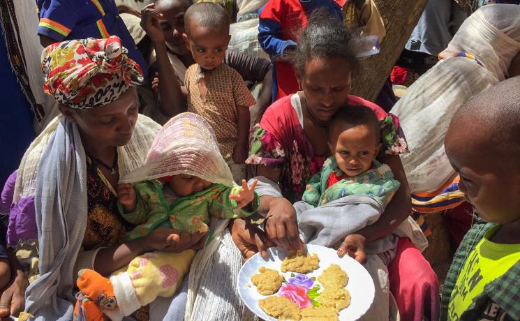 People taste the pancakes made in a cooking distribution with the enriched “Famix” flour, distributed to displaced people in Tigray. All photos: LWF/ S. Gebreyes 