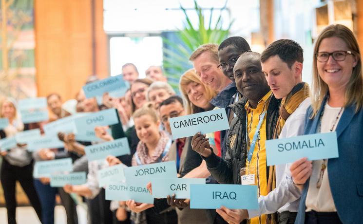 World Service staff attending the GLTM hold the names of the countries where they are working. Photo:LWF/A. Hillert
