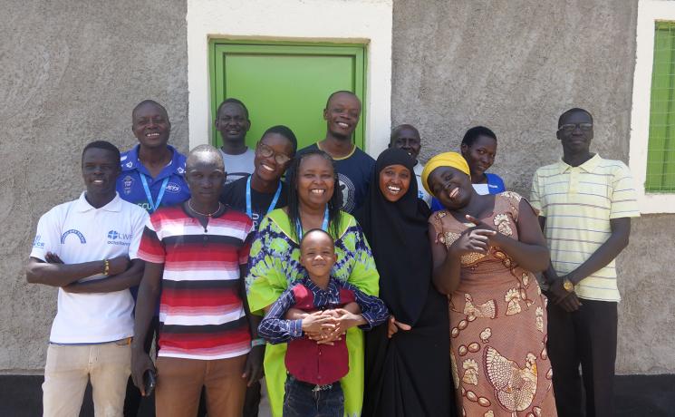 Residents from Kakuma refugee camp in northwest Kenya pose for a photo after taking part in an LWF-run workshop to write poems for the ‘I am Hope’ publication. Jackline Irankunda is pictured in the front row, furthest to the right. Photo: LWF/O. Schnoebelen