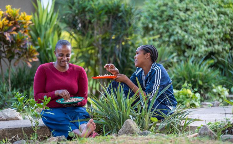Two friends enjoy a meal on the campus of the ELCT-Diocese of Meru, Usa River Rehabilitation and Training Centre for people with special needs, in Arusha, Tanzania. All photos: LWF/Albin Hillert 
