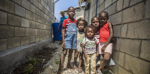 Tiny survivors of the 2010 Haitian earthquake gather outside the Model Resettlement Village in Gressier  