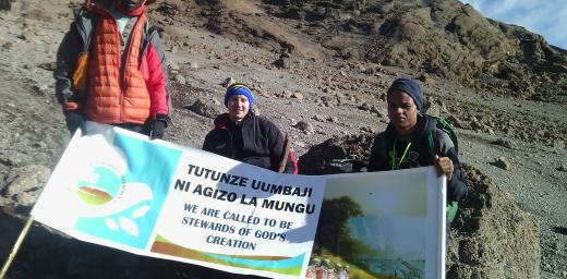 Young Lutherans unfurl the banner they erected at the summit of Mt Kilimanjaro, as the Lutheran African Leadership Conference was being held in Moshi, Tanzania, to raise awareness of the need by Lutherans to protect the environment. Photo: Tsion Alemayehu