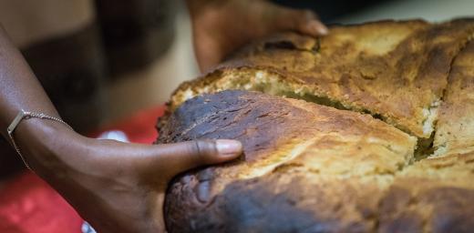 Traditionally baked Ethiopian bread being shared out with participants at a global consultation on Lutheran identities in Addis Abeba in October 2019. Photo: LWF/Albin Hillert