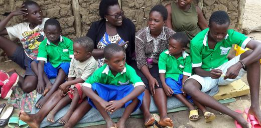 An adult to take charge: Betty Lamunu, center, of LWF Uganda, offered some motherly care to an orphaned family. Photo: LWF Uganda/Z. Asianju
