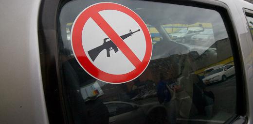 A sticker advises that weapons are not carried in the vehicle. Photo: ACT Alliance