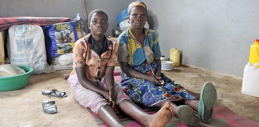  Caption: Bernadetta Myanura and her granddaughter Feza in the few square meters they have to themselves in the reception center. Photo: M. Renaux