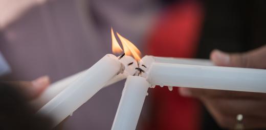 Lighting candles during a prayer at COP25 in Madrid, Spain. Photo: LWF/Albin Hillert