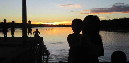 Children watch the sunrise at the Arauca river, Colombia. Photo: LWF