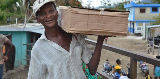 A beneficiary receives a shelter kit in a joint LWF/Diakonie Katastrophenhilfe distribution in Petit Goave. Photo: LWF Haiti