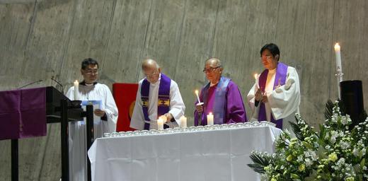 Prof. H. Augustine Suzuki (second left) lights a candle at St Maryâs Cathedral in Tokyo, where Anglicans, Catholics and Lutherans held the first joint worship service. Photo: JELC