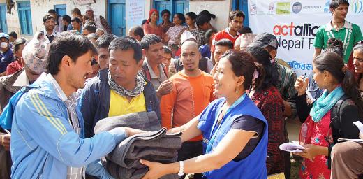 LWF staff offer blankets to earthquake survivors in Lalitpur district. Photo: LWF/C. KÃ¤stner
