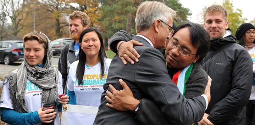 LWF general secretary Rev. Dr Martin Junge greets climate campaigner Yeb SaÃ±o as SaÃ±o and 17 other pilgrims arrive in Geneva on a march from Rome to Paris to push for a new climate deal. Photo: LWF/S. Gallay