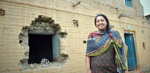 Rosni Paryar, in front of her partially destroyed home. She fear she will remain unemployed because she of the Dalit caste. Photo: LWF/Lucia de Vries