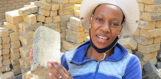 Bricklayer Makhatutu Siimane, showing what she can do with bricks. Photo: Outreach Foundation