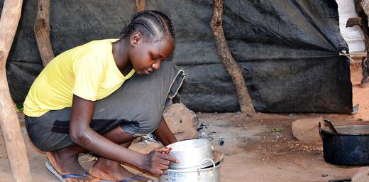 Sudanese refugee Amona Tia prepares the evening meal for her siblings at the Ajuong Thok refugee camp in South Sudan. With help from the LWF, she has resumed schooling. Photo: LWF/A. Kiura