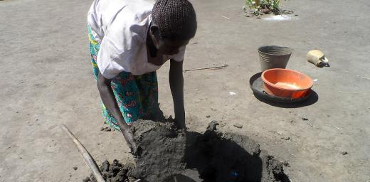 Margret Akot collects clay for the stoves. Photo: LWF Uganda