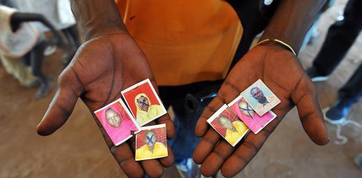 A refugee hold images of family members killed in the South Sudan conflict, Njumanzi reception center, Adjumani, Uganda. Photo: LWF/ M. Renaux