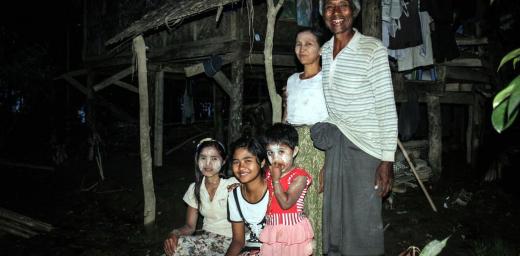 U Kyaw Thein and his family in front of their flood-affected home. Photo: LWF Myanmar/ M. Celiz