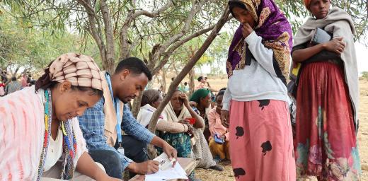 An LWF cash distribution in Tigray. The payments are being checked with ID cards, and signed for with finger prints. Photo:LWF/ Daniel ZeMichael