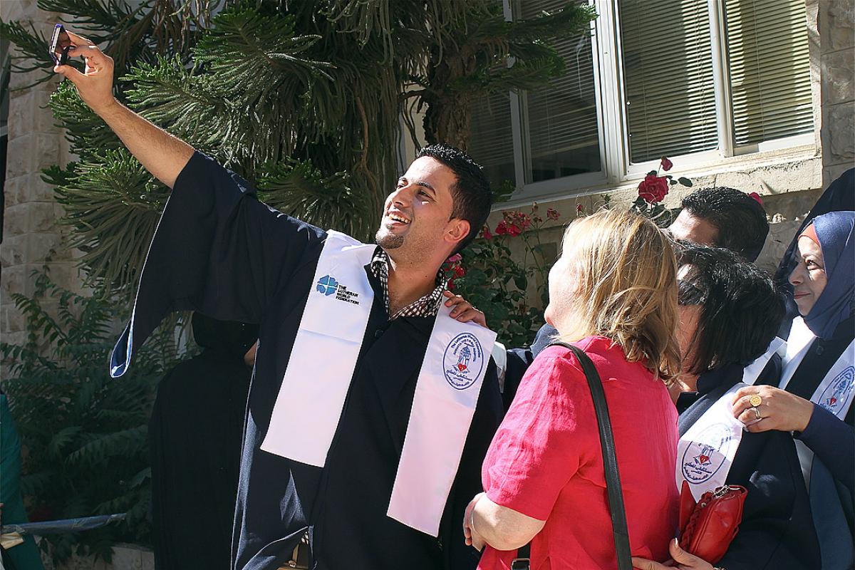 An AVH graduate shares his excitement with a selfie at a reception after the graduation ceremony. Photo: LWF Jerusalem/ T. Montgomery