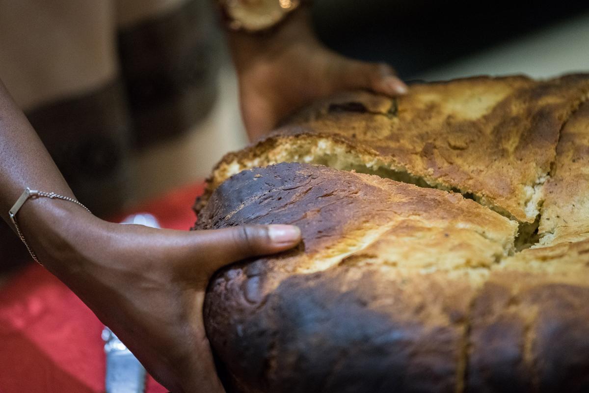 Traditionally baked Ethiopian bread being shared out with participants at a global consultation on Lutheran identities in Addis Abeba in October 2019. Photo: LWF/Albin Hillert