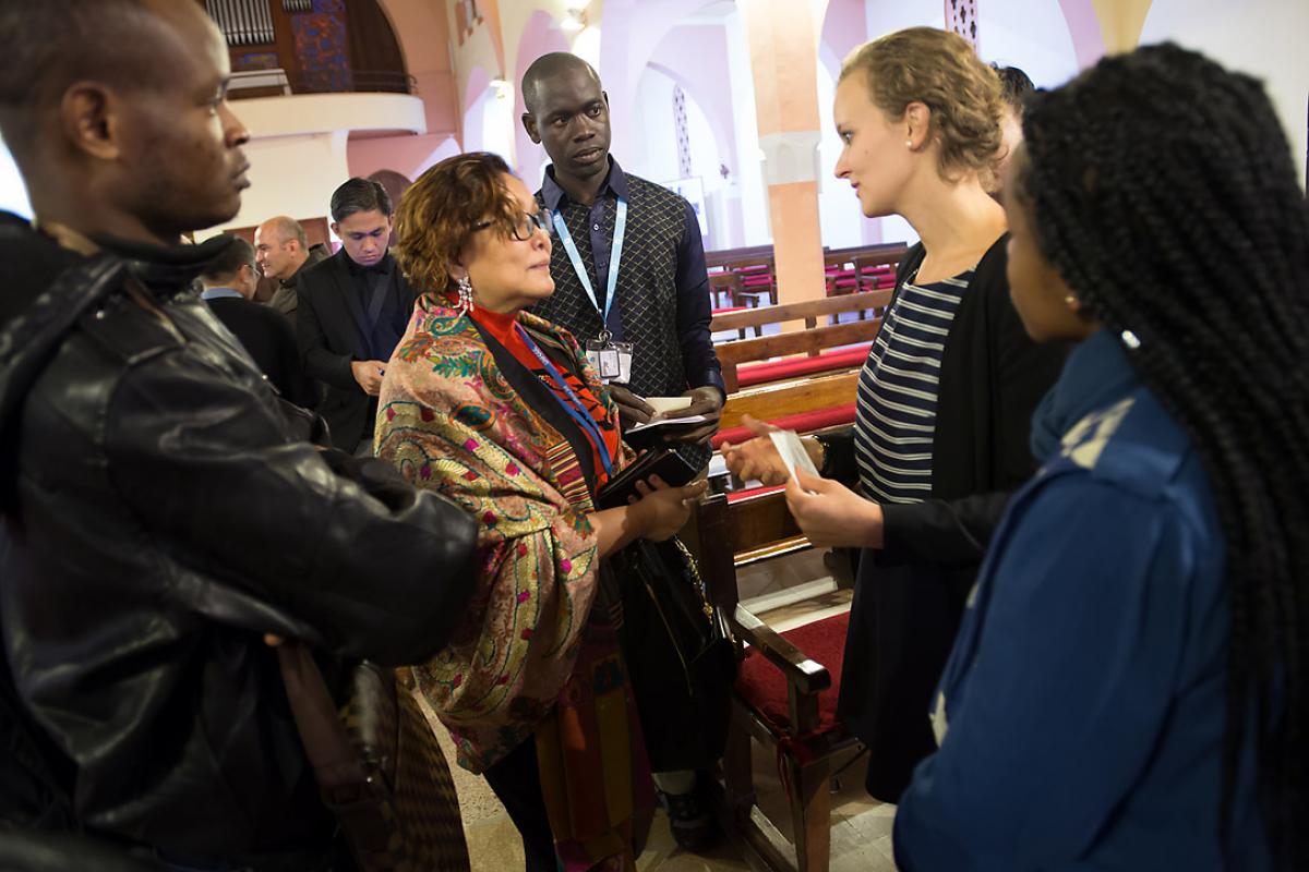LWF’s representatives at the COP 22 talks in Marrakech, Morocco, participated in an ecumenical "Prayer for the Planet" at the Roman Catholic Church of the Holy Martyrs, 8 November. Gloria Jumamil-Mercado, head of the Philippine government delegation (center) meets LWF Youth Secretary Caroline Bader and LWF delegation members [l-r] Cédrick Yumba Kitwa (Democratic Republic of Congo); Pascal Kama (Senegal); and Ditebogo Caroline Lebea (South Africa). Photo: LWF/Ryan Rodrick Beiler