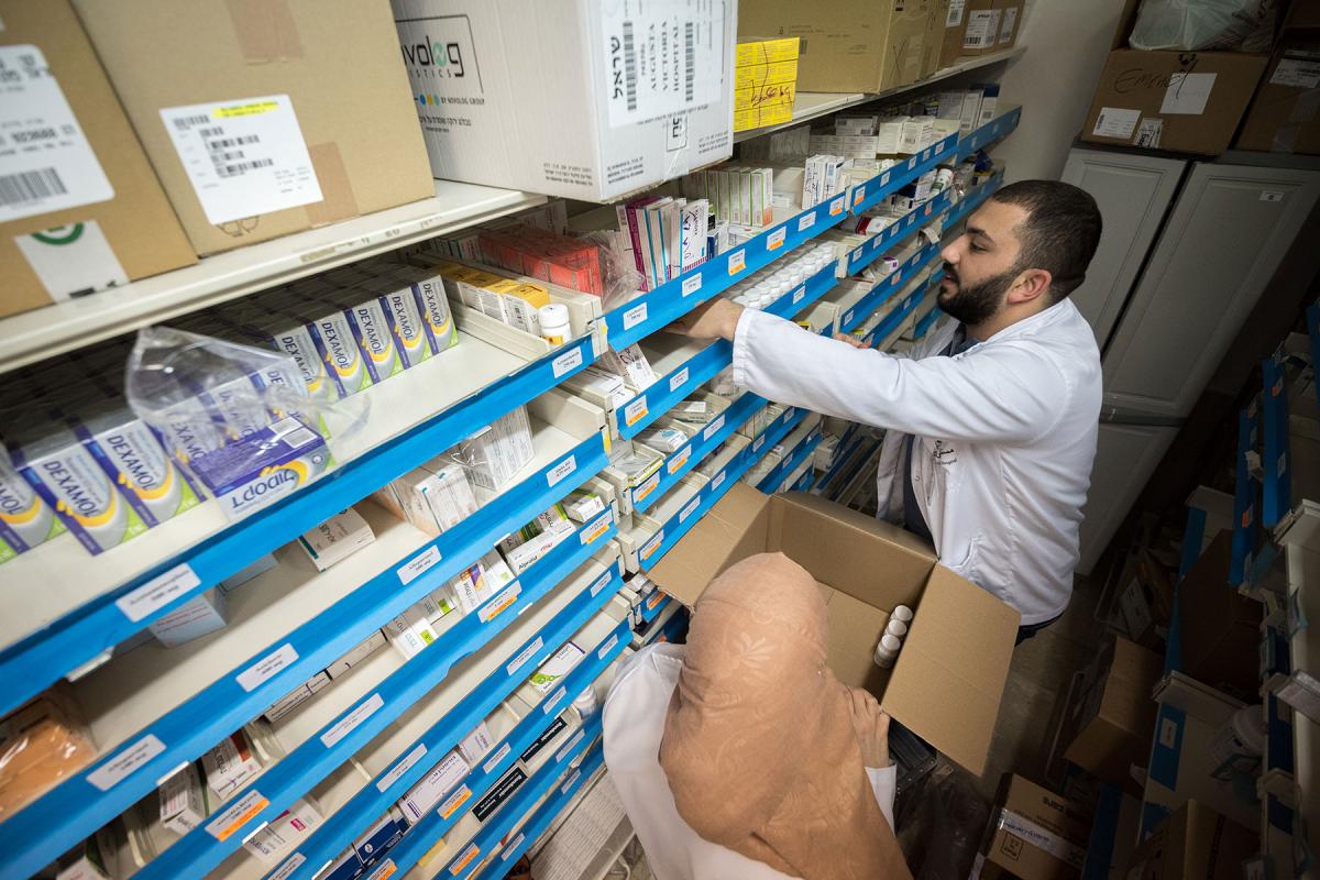 Dr Farmacist Nicolas Saliba restocks medicine at Augusta Victoria Hospital, Jerusalem. Photo: LWF/Albin Hillert