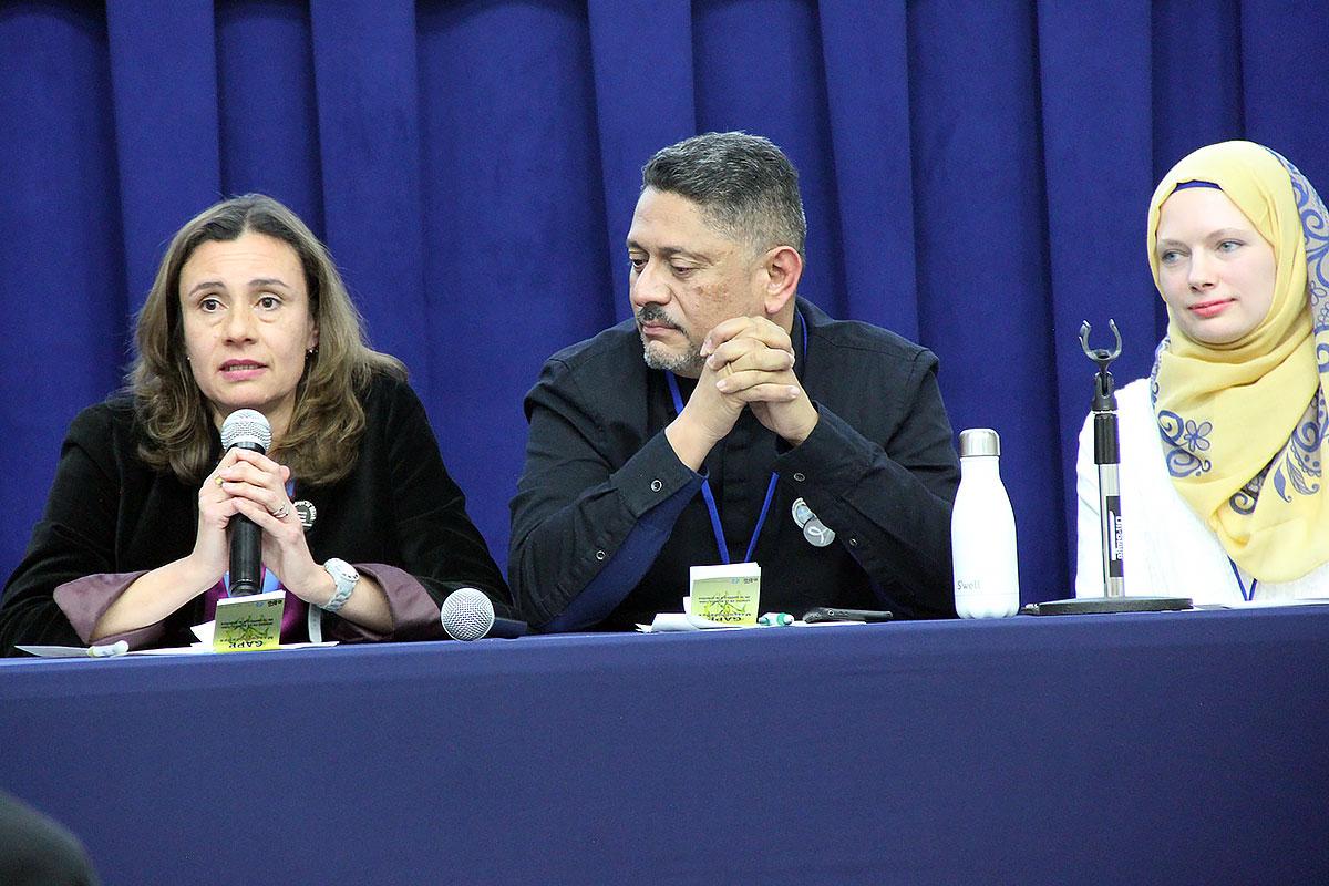 María Cristina Rendón, program assistant in LWF Women in Church and Society speaks at the panel discussion. With her is LWF delegate Larry Madrigal Rajo, and Iman Sandra Pertek (right).