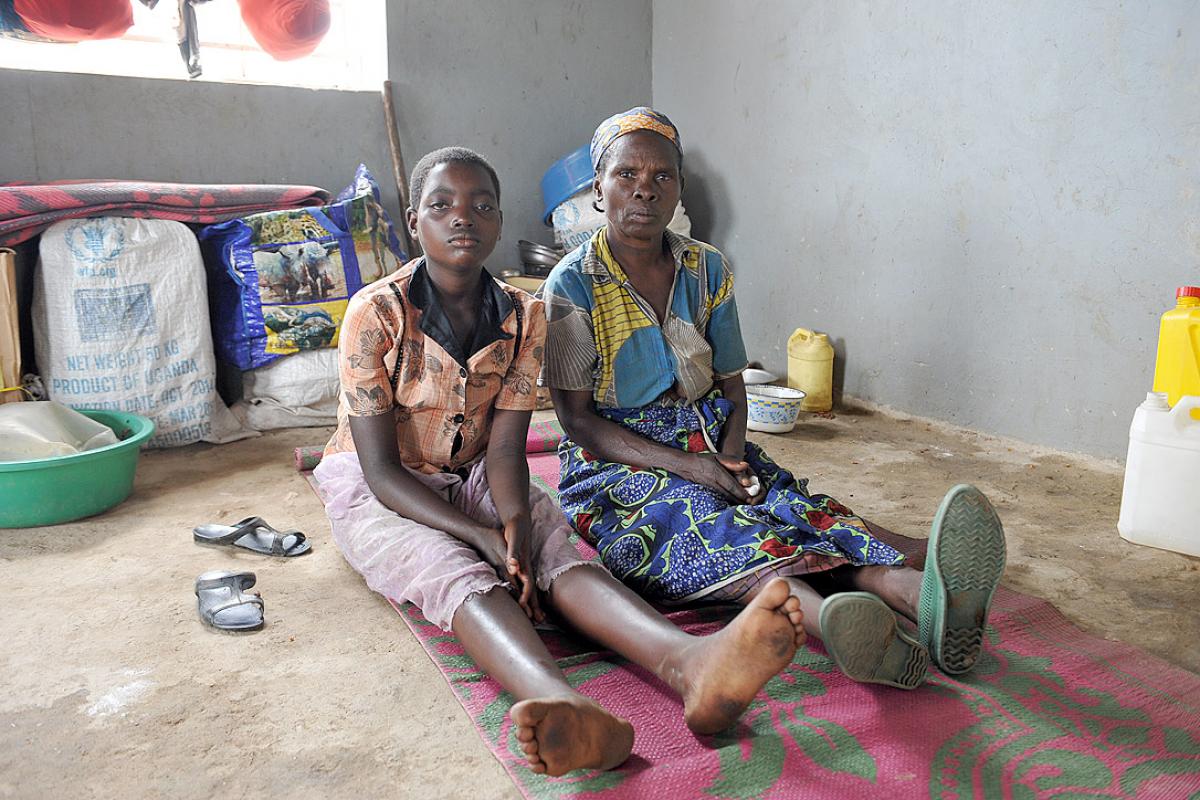  Caption: Bernadetta Myanura and her granddaughter Feza in the few square meters they have to themselves in the reception center. Photo: M. Renaux