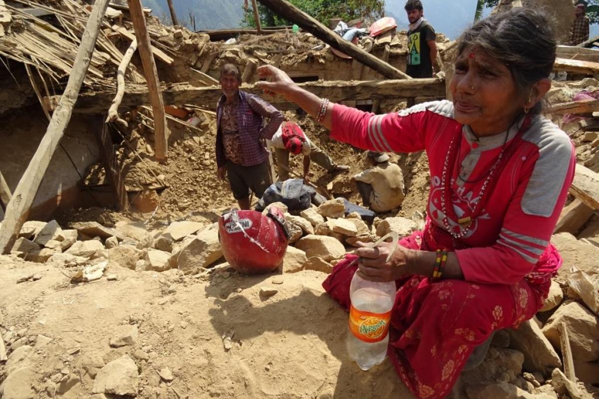After the earthquake in Nepal, local villager searches for cooking utensils in the debris.  Photo:  LWF/C.Kaestner