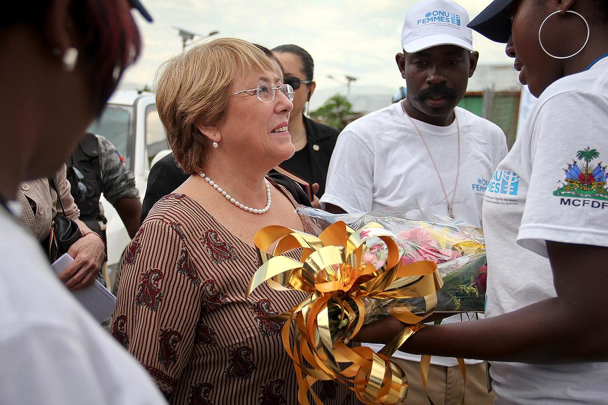 Michelle Bachelet receives flowers during a visit to Haiti in 2012 during her tenure as UN Women executive director. Photo: UN Women (CC-BY-NC-SA)