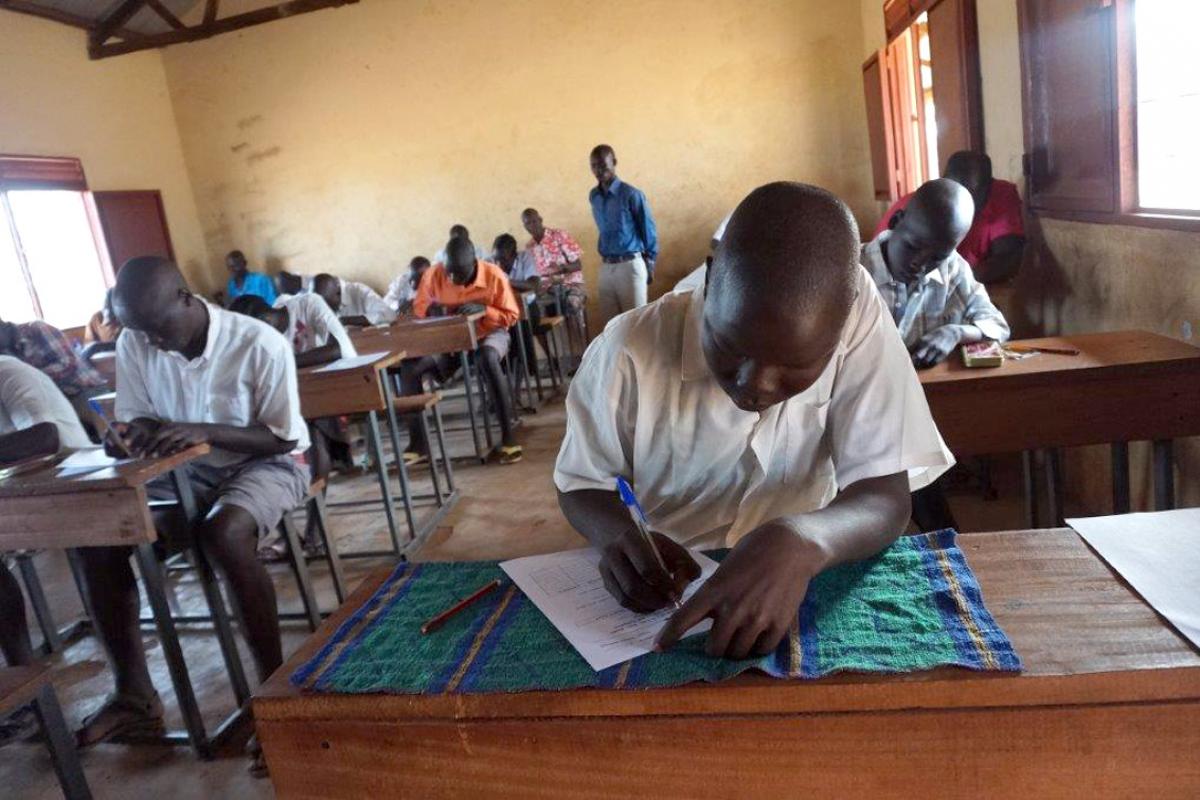 Primary school students sit their final examination at Napata school in Ajoung Thok refugee camp, South Sudan. Photo: LWF South Sudan