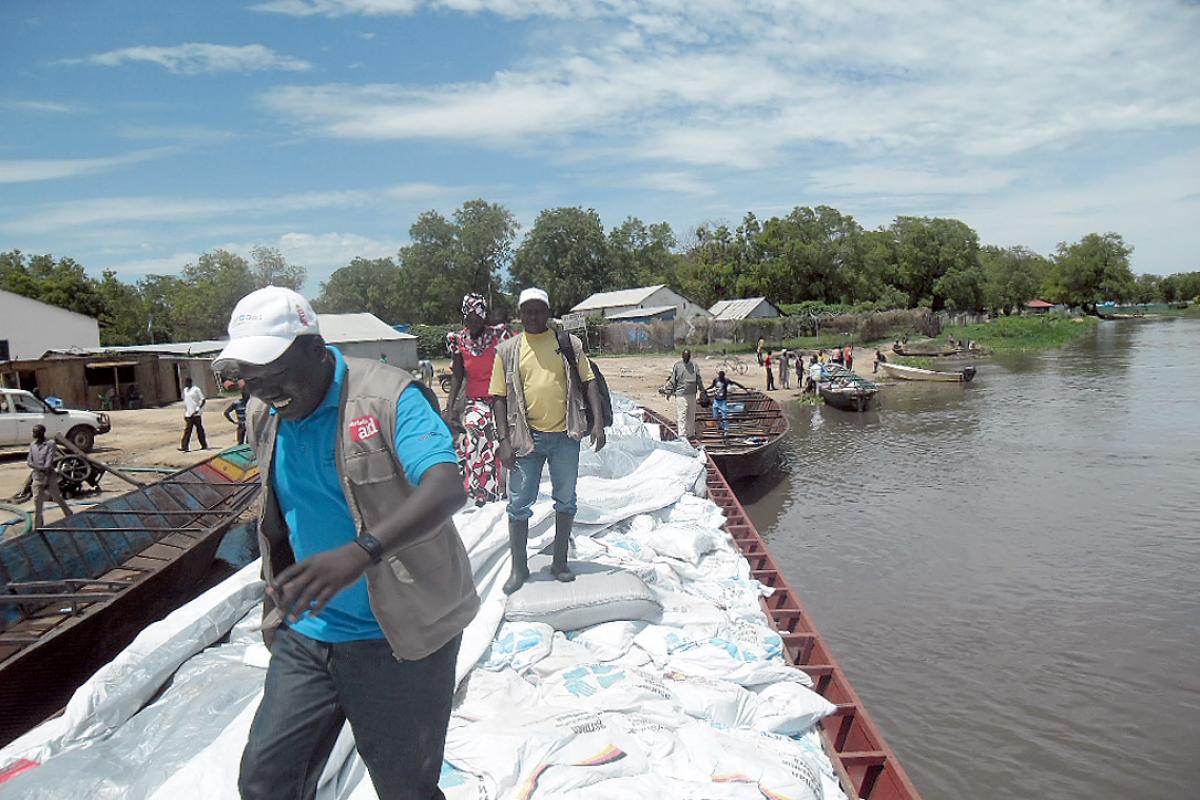 NFIs from the LWF and partner organizations are ferried by boat to remote islands in Twic East County, South Sudan. Photo: LWF South Sudan/George Taban
