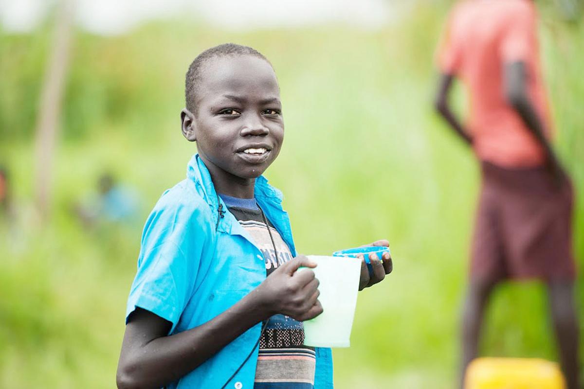 A young South Sudanese refugee eats porridge in Northern Uganda. Photos:LWF/Uganda
