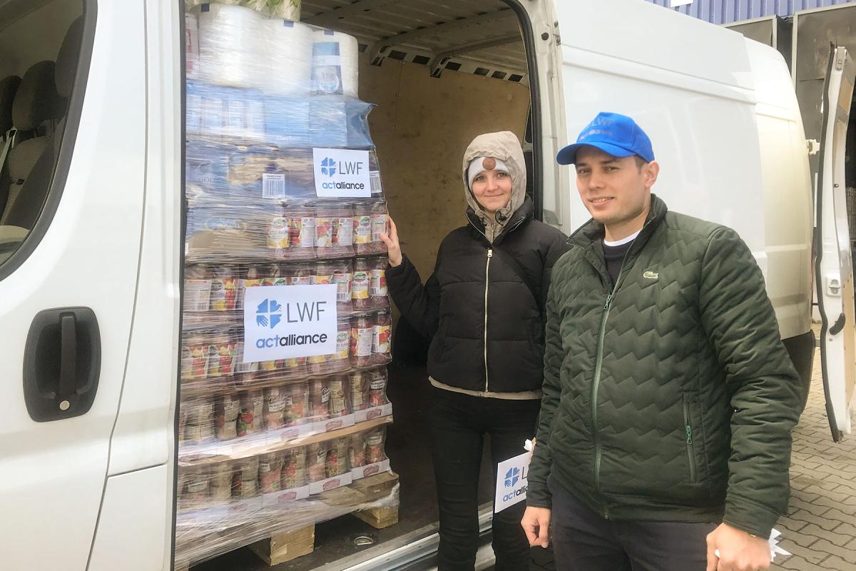 LWF humanitarian support officer Katerina Brzicova and Samuel Reslour, a volunteer, assist in transporting relief items to a warehouse of the Polish Humanitarian Action (PAH), which is partnering with the LWF to distribute food and non-food items to refugees fleeing from Ukraine at the Zosin and Dohoruth borders. Photo: B. Khanal