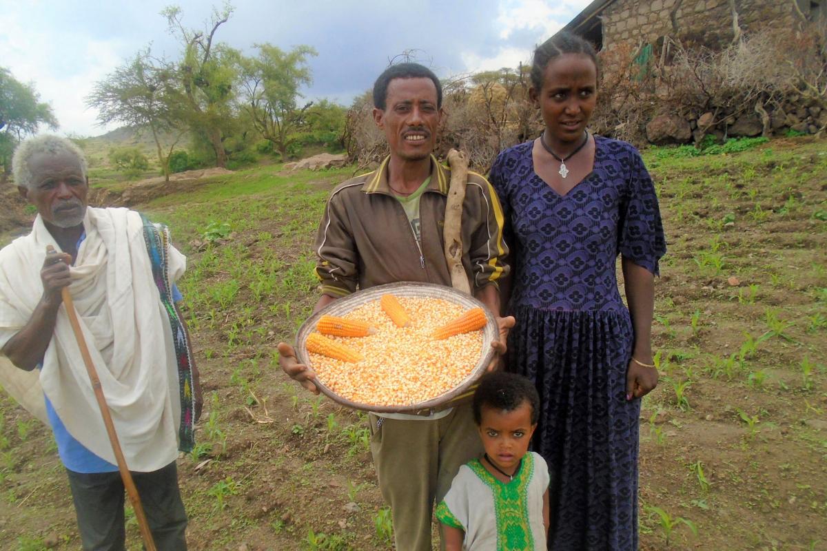 Amare Mulaw and his family, showing his ‘Lutheran’ corn. Photo: LWF/ Yitbarek FREW